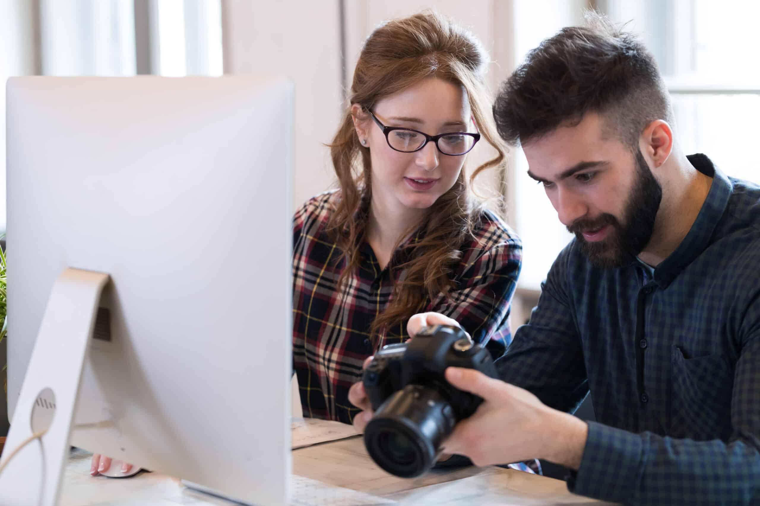 Two young designers working in modern office